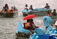 Two girls as also tourists caught in the rain at Sukhna Lake, Chandigarh
