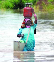 A woman retrieves household items from the area