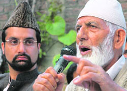 APHC chairman Syed Ali Shah Geelani addresses the press in Srinagar on Sunday as Mirwaiz Omar Farooq looks on.