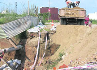 A portion of the road in Shaheed Bhagat Singh Nagar that caved in due to rain and digging for the City Centre project in Ludhiana.
