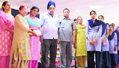 Gurdash Singh Grewal, treasurer, Khalsa Diwan, distributes scholarships among students during a function organised by the Bharat Vikas Parishad in Ludhiana on Sunday.