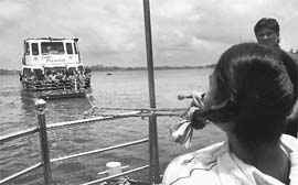 Woman power: Rani Raikwar of Bhopal pulling a 16,000 kg weight cruise boat by her hair in Bhopal on Sunday.