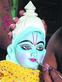 An artist paints an idol of Lord Krishna at a workshop in Mathura on Sunday. Janmashtami, which marks the birthday of Lord Krishna, will be celebrated on August 24.