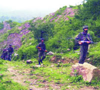 Army personnel carry out a search operation in an interior area of Chamba district. 