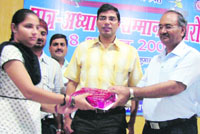 A student being honoured at a function in Kaithal.
