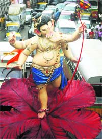 Devotees carry a huge idol of Lord Ganesha in Maharashtra