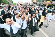 NO HOLDS BARRED: Lawyers celebrate the resignation of President Pervez Musharraf during a march on a street in Karachi on Monday.