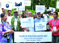 Professional and amateur photographers of 'The School of Fototechnik' participate in a march to mark 'World Photography Day' in New Delhi 
