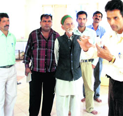 Officials interact with villagers.