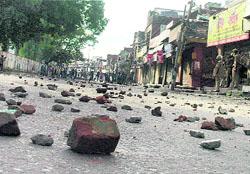 Stones and brickbats litter a road during a clash between the police and protesters over the Amarnath land row in Jammu on Tuesday.