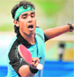 Kamal Sharath Achanta plays against Spain's Alfredo Carneros in the mens singles preliminary round table tennis match at the Peking University gymnasium in Beijing