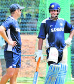 Mahendra Singh Dhoni (R) speaks with coach Gary Kirsten during a training session at The Rangiri Dambulla International stadium in Dambulla