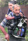 An elderly Georgian couple escapes from a house set on fire by South Ossetian militia in a village outside Tskhinvali
