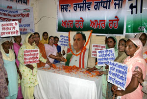 Congress workers observe the birth anniversary of Rajiv Gandhi in Bathinda on Wednesday.