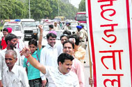 Government employees and aaganwadi workers block traffic during strike on the Sectors 34-35 roundabout in Chandigarh on Wednesday