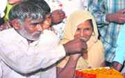 Parents of Sushil Kumar celebrate his victory in Baprolla village near Delhi