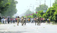 Policemen chase protesters