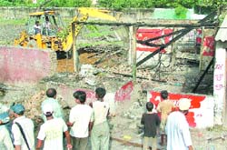 The cantonment board authorities carry out an anti-encroachment drive in Jalandhar on Wednesday.