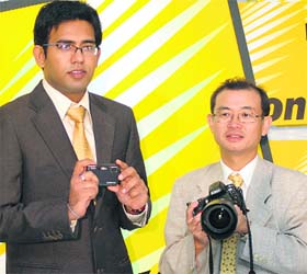 Hidehiko Tanka (R), managing director, Nikon (India) with Nikon marketing head Prasant Singh posing with Nikon D700 digital SLR camera during a launch in New Delhi
