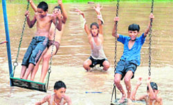 Schoolchildren have a ball at a flooded park in Sector 11,Chandigarh