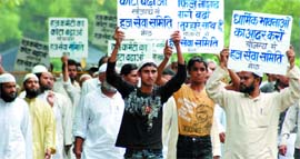 Members of the Haj Sewa Samiti demonstrate near Parliament, demanding increase in the Haj quota in New Delhi on Thursday