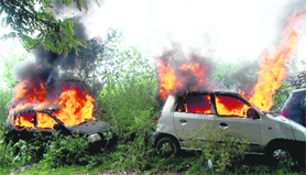 Protester set vehicles on fire in Jammus Bhagwati Nagar on Thursday.
