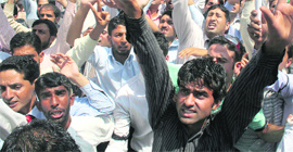 Members of the All-Kashmir Medical Representatives Association hold a demonstration at Lal Chowk in Srinagar on Thursday.