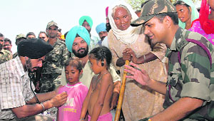 Doctors of the Health Department and the Army examine patients at Akbarwala village in Ferozepur district on Thursday. 