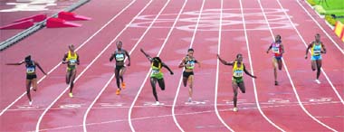 Veronica Campbell-Brown (3rd R) of Jamaica crosses the finish line first to win the womens 200m final of the athletics competition in the National Stadium on Thursday. Allyson Felix (4th R) of the U.S. finished second and Kerron Stewart (4th L) of Jamaica third.