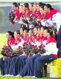 The US soccer team is all smiles as they hold up their medals during the medal ceremony after they beat Brazil in the womens soccer gold medal match on Thursday. US won 1-0 after extra time.  AP/PTI