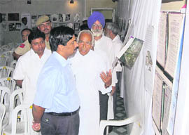 Sirsa deputy commissioner V.Umashankar goes around a photo exhibition at Sirsa on Friday on the devastating effects of the atom bomb in Hiroshima and Nagasaki.