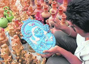 An artist paints an idol of Lord Krishna ahead of Janamashtmi at a workshop in Shimla.
