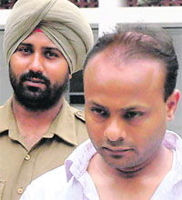 Rajiv Gupta being produced in District Courts, Sector 17, on Friday. 