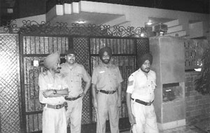 Policemen stand outside the house of Sanjeev Bansal in Sector 8, Chandigarh, as a city police team carries out a search in his house on Friday.