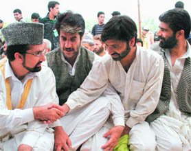 Chairman of the moderate faction of the Hurriyat Conference Mirwaiz Umar Farooq (extreme left) shakes hand with JKLF chief Yaseen Malik during Friday prayers at Eidgah in Srinagar on Friday.