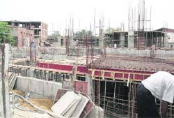 A commercial building that is coming up without leaving space on the front and sides, thereby violating bylaws in Ludhiana