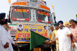 SAD president Sukhbir Singh Badal flagging of trucks carrying relief material for flood-affected people in Bathinda