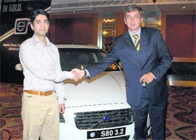 Abhinav Bindra shakes hands with Paul de Vojis, managing director, Volvo Car, India, at a function held in Chandigarh