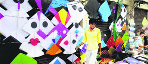 A vendor sells kites on the eve of Janmashtami in Jammu on Saturday.