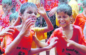 Visually challenged schoolchildren dance during Janmashtami celebration in Mumbai on Saturday.