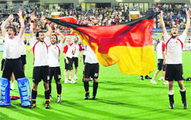 Germanys players celebrate their gold medal victory over Spain in hockey final at the Olympic Green Hockey Stadium on Saturday.