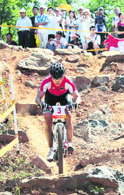 Germany's gold medal winner Sabine Spitz competes in the women's cross country mountain bike race of the 2008 Beijing Olympic Games on Saturday at the Laoshan Cycling venue in Beijing. Germany Sabine Spitz won gold while Maja Wloszcowska of Poland took silver and Catharine Pendrel of Canada claimed bronze. 