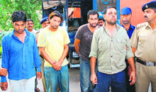 The four arrested robbers being taken to the operation cell in Sector 26, Chandigarh, on Sunday.