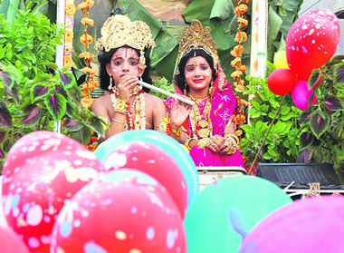 Children dressed as Lord Krishna and Radha during a shobha yatra on the occasion of Janmashtami in Karnal on Sunday.