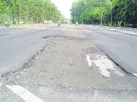 A view of the National Highway before the raised structures and debris were removed; and (right) as it looks now.