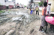 Stagnant water in a vacant plot in Gyaspura has become a breedng ground for mosequitoes; slush and filth dot the approach road to Ambedkar Nagar and (right) Patients undergoing treatment for gastroentritis at a hospital in Giaspura in Ludhiana.