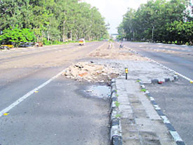 A view of the National Highway before the raised structures and debris were removed; and (right) as it looks now.