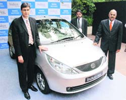 Tata Motors president, passenger cars division, Rajiv Dubey (L) and vice-president, commercials, S Krishnan, pose with New Indica Vista at its launch in New Delhi on Monday. The car is priced between Rs 2.6 lakh and Rs 4.88 lakh.