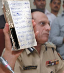 Delhi police commissioner Y.S. Dadwal displays the telephone book of Bunty at a press conference in New Delhi
