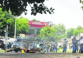 RAF personnel fire tear gas shells in Jammus Digiana area to disperse a rampaging mob on Monday
